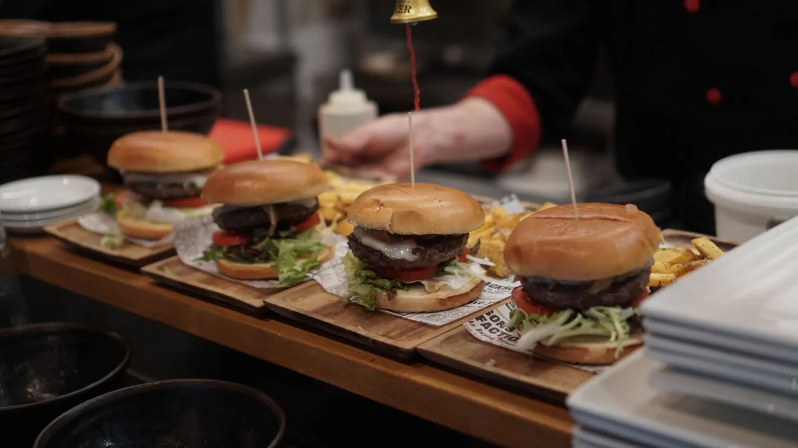 Freshly prepared gourmet burgers with fries ready to be served at a restaurant.